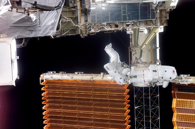 NASA image: STS-116 Crewmembers Curbeam and Williams work near P6 SAW during EVA 3