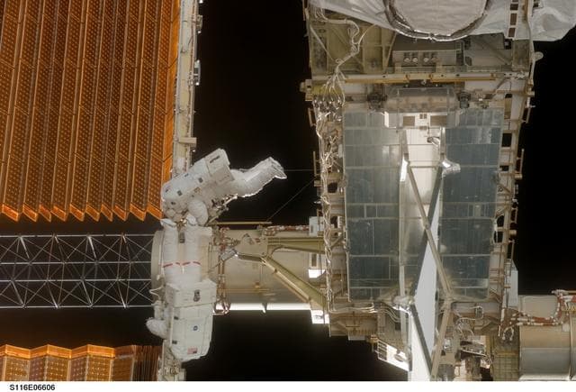 NASA image: STS-116 Crewmembers Curbeam and Williams work near P6 SAW during EVA 3