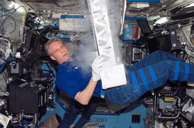 NASA image: Expedition 14 FE Reiter work on POEMS payload in the U.S. Laboratory during Joint Operations