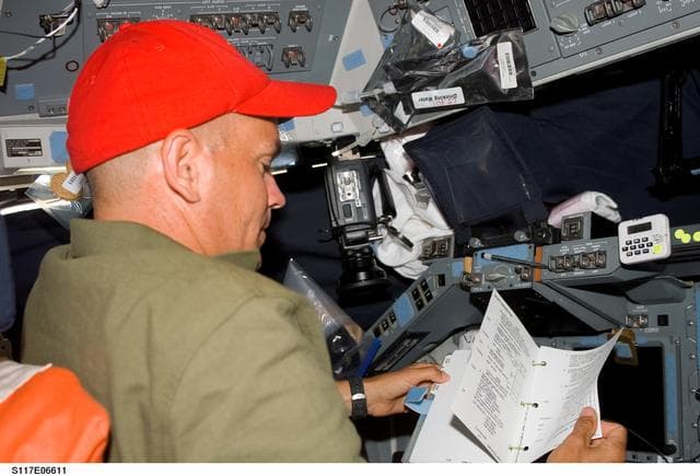 NASA image: Sturckow looks over procedures on the FD of STS-117 Space Shuttle Atlantis
