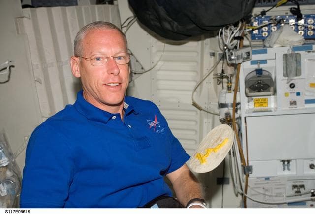 NASA image: Forrester poses with floating torilla in the MDDK on STS-117 Space Shuttle Atlantis