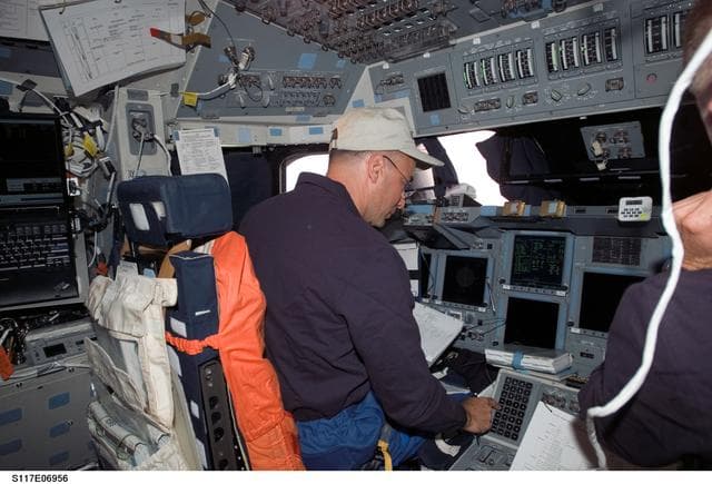 NASA image: Archambault looks at crew procedures in the FD on STS-117 Space Shuttle Atlantis