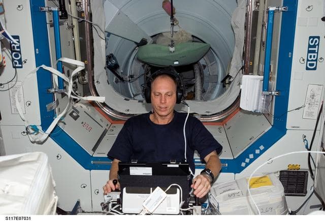 NASA image: Anderson works with the TRAC experiment in the U.S. Laboratory during Joint Operations