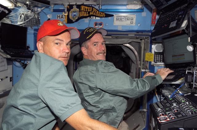 NASA image: Olivas and Anderson works at laptop computer in the U.S. Laboratory during Joint Operations