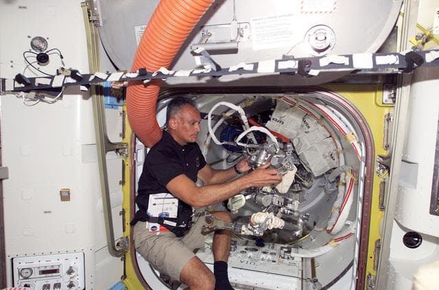 NASA image: Olivas works with EVA Tether in the A/L during Joint Operations