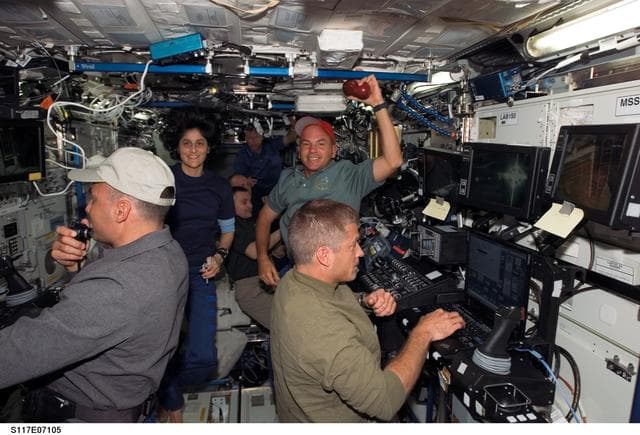 NASA image: Expedition 15 and STS-117 crewmembers working in the U.S. Laboratory during Joint Operations