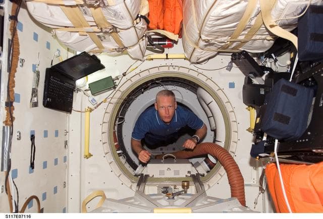 NASA image: Forrester floats through hatch to the MDDK of STS-117 Space Shuttle Atlantis during Joint Operations