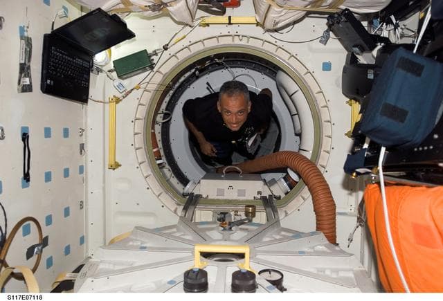 NASA image: Olivas floats through hatch to the MDDK of STS-117 Space Shuttle Atlantis during Joint Operations