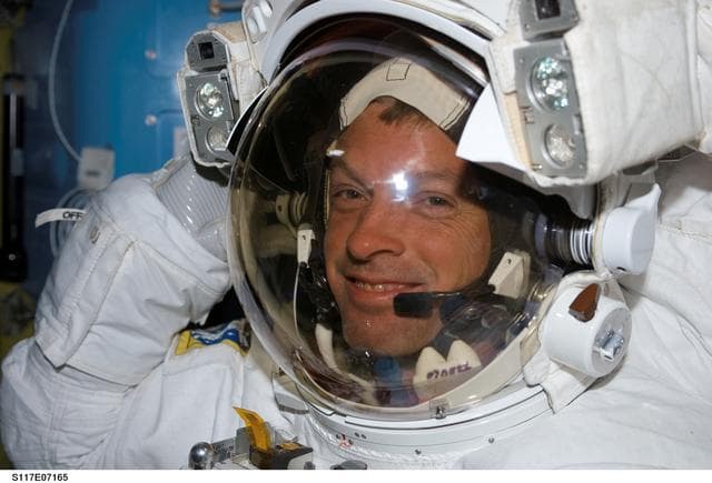NASA image: Swanson wearing EMU in the A/L during Joint Operations