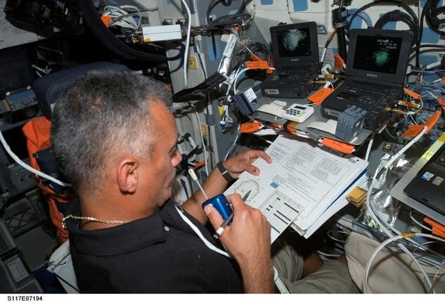 NASA image: Olivas uses communication equipment on the FD during Joint Operations