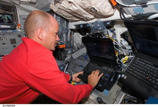 NASA image: Astronaut Rick Sturckow, STS-117 commander, uses a computer on the FD during Joint Operations