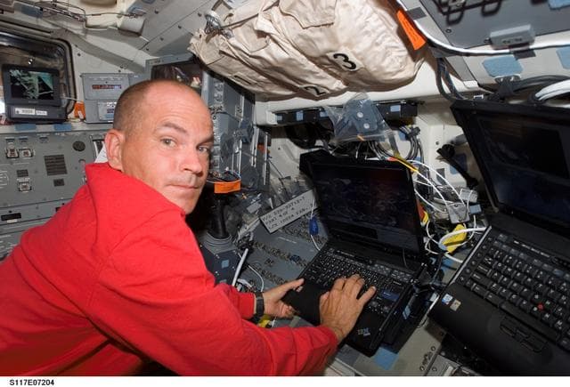 NASA image: Astronaut Rick Sturckow,STS-117 commander, uses a computer on the FD during Joint Operations