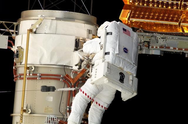 NASA image: Swanson prepares to retract the P6 Truss STBD SAW during EVA 2