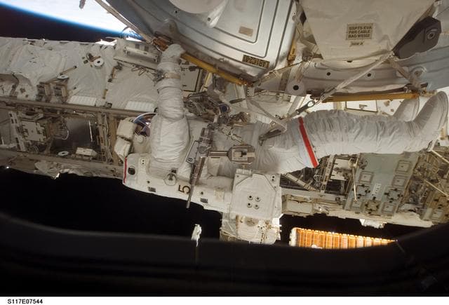 NASA image: Reilly installs a water to hydrogen vent on the outside of the U.S. Laboratory during EVA 3