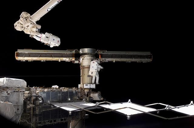 NASA image: Reilly and Olivas try to retract the final bay of the P6 Truss STBD 2B SAW during STS-117 EVA 3