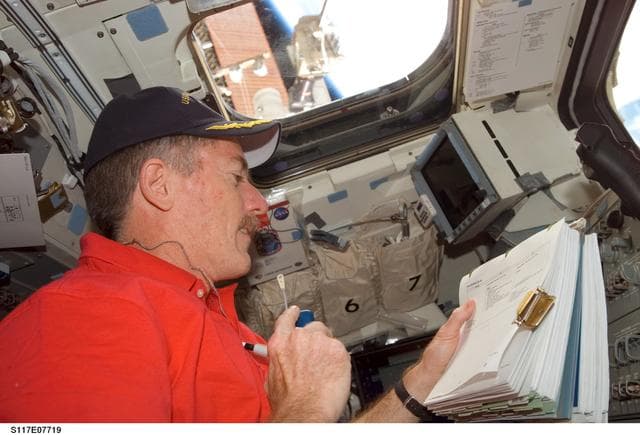 NASA image: Reilly uses communication equipment in the aft FD on Space Shuttle Atlantis during Joint Operations