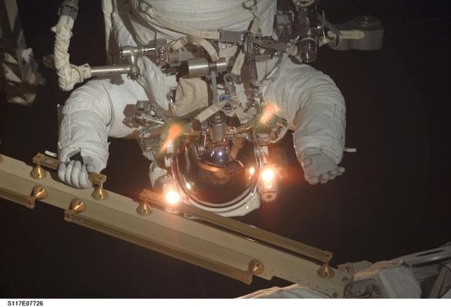NASA image: Forrester holds onto handrails during EVA 4