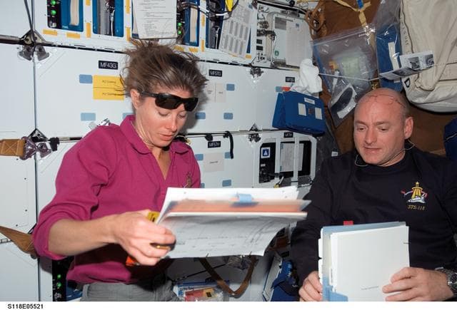 NASA image: View of Kelly and Caldwell working in the MDDK during STS-118