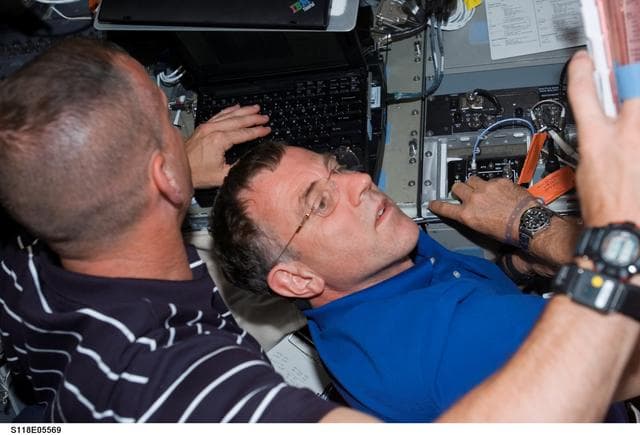 NASA image: View of Hobaugh and Williams working in the FD during STS-118