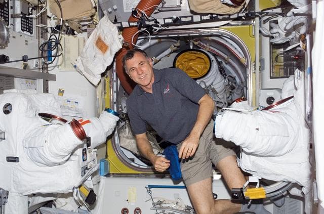 NASA image: View of MS Williams posing with EMUs in the A/L during STS-118