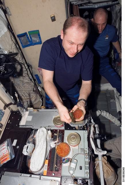 NASA image: View of FE Kotov preparing a meal in the SM