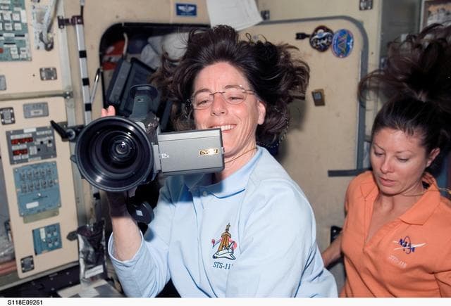 NASA image: View of Crewmembers in the SM during STS-118/Expedition 15 Joint Operations