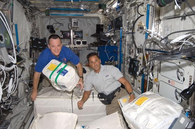 NASA image: Arnold and Acaba with Stowage in European Laboratory Columbus