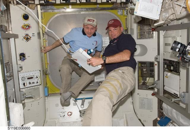 NASA image: Fincke and Antonelli in Joint Airlock Quest with Procedures binder