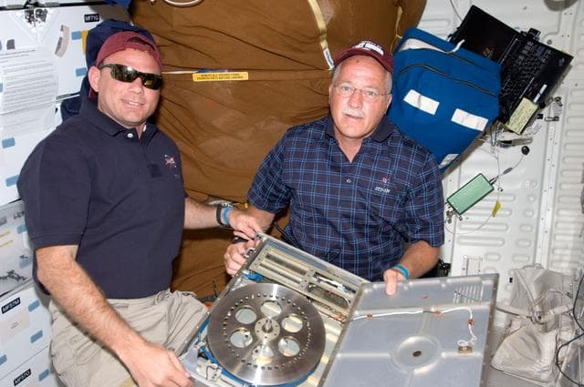 NASA image: Antonelli and Phillips setup Cycle Ergometer on Middeck (MDDK)