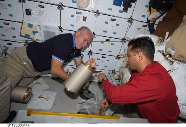 NASA image: Phillips and Acaba work with LiOH cartridges on Middeck (MDDK)