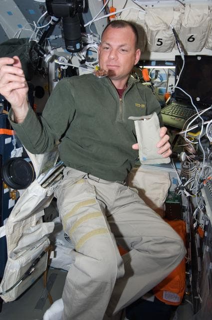 NASA image: Antonelli with Food packet on AFT Flight Deck (FD)