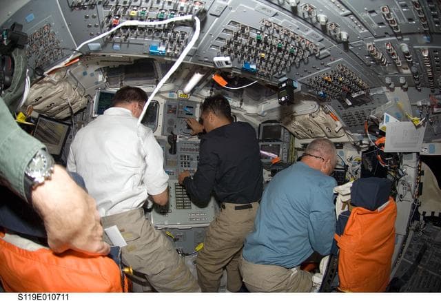NASA image: Archambault, Acaba and Phillips on AFT flight deck (FD) for OBSS OPS