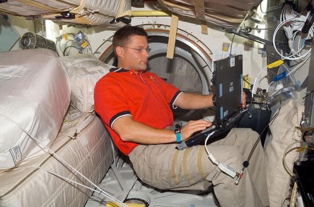 NASA image: Wheelock with computer on Discovery middeck