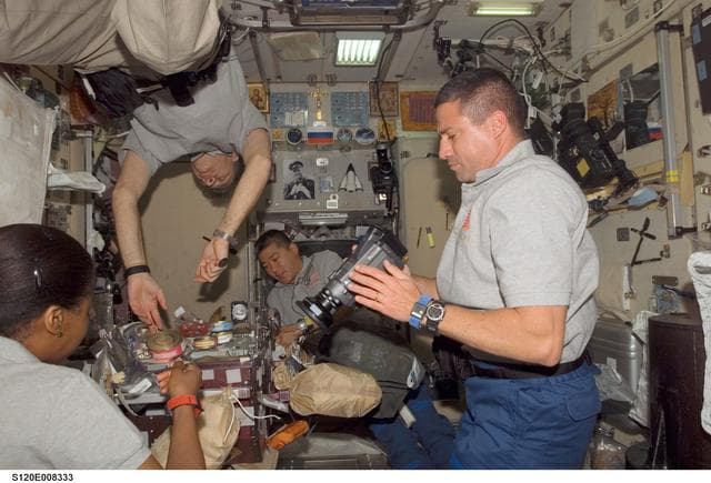 NASA image: STS-120 and Expedition 16 crew share meal in Zvezda module