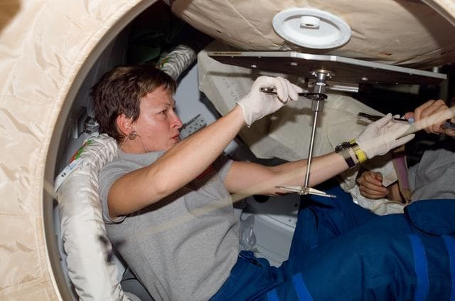 NASA image: Whitson prepares to close PMA2 hatch