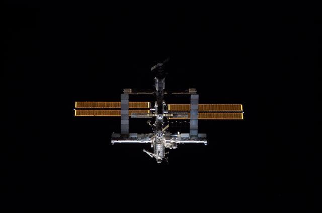 NASA image: Nadir view of the ISS as the orbiter Discovery moves in for docking during STS-121