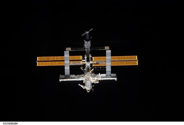 NASA image: Nadir view of the ISS as the orbiter Discovery moves in for docking during STS-121