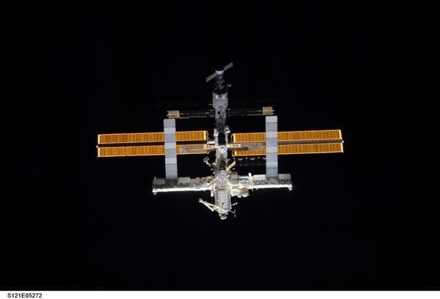 NASA image: Nadir view of the ISS as the orbiter Discovery moves in for docking during STS-121