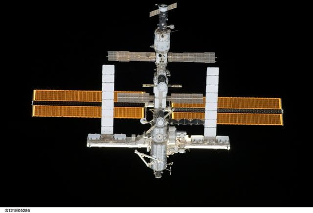 NASA image: Nadir view of the ISS as the orbiter Discovery moves in for docking during STS-121