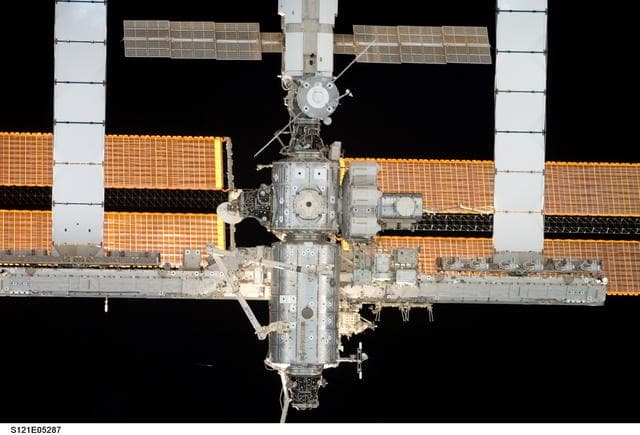 NASA image: Nadir view of the ISS as the orbiter Discovery moves in for docking during STS-121