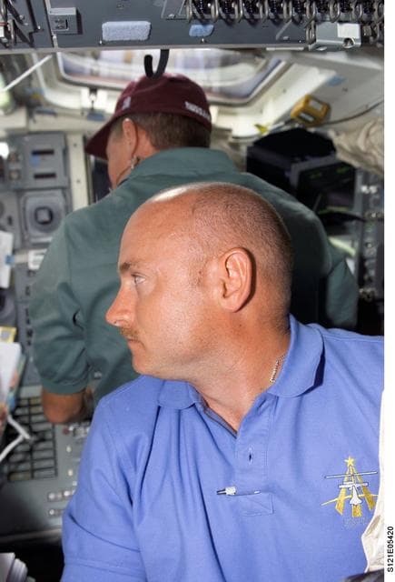 NASA image: Kelley and Fossum on flight deck during RMS survey OPS on STS-121