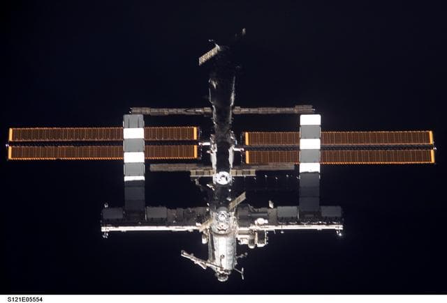NASA image: Nadir view of the ISS as the orbiter Discovery moves in for docking during STS-121