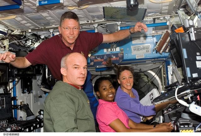 NASA image: Exp. 13 and STS-121 crewmembers work in the U.S. Lab during STS-121/Exp. 13 OPS