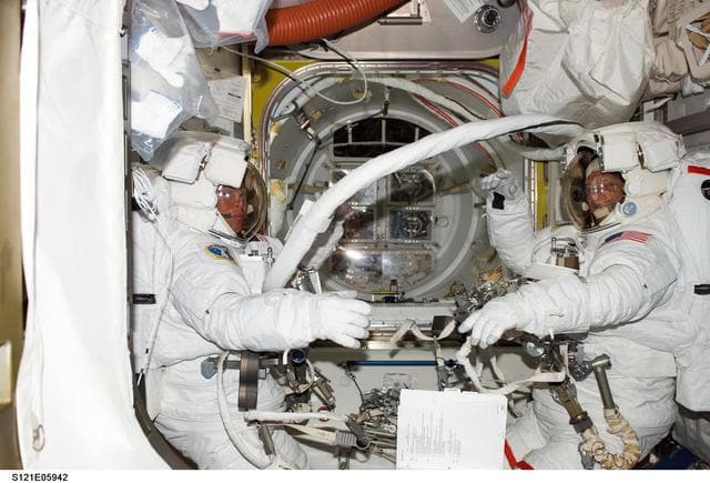 NASA image: Sellers and Fossum in EMUs inside the A/L before their EVA1 during STS-121 / Exp. 13 joint OPS