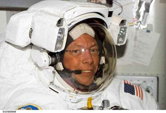 NASA image: Fossum, smiles at the camera, as he wears his EMU inside the A/L before EVA1 during STS-121 / Exp. 13 joint OPS