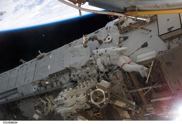 NASA image: Sellers routes new TUS-RA cable during EVA2 for STS-121 / Expedition 13 joint operations