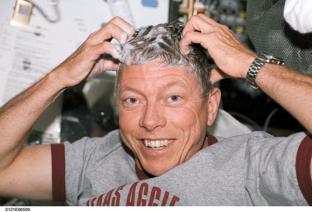 NASA image: Fossum washes his hair during STS-121 / Expedition 13 joint operations