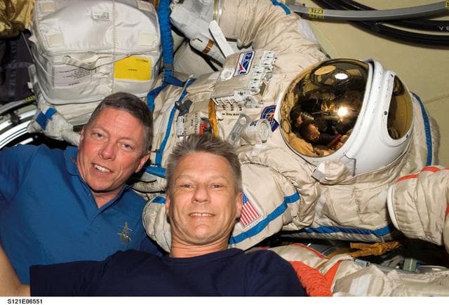 NASA image: Fossum and Sellers with Orlan Suit inside the DC during STS-121 / Expedition 13 joint operations