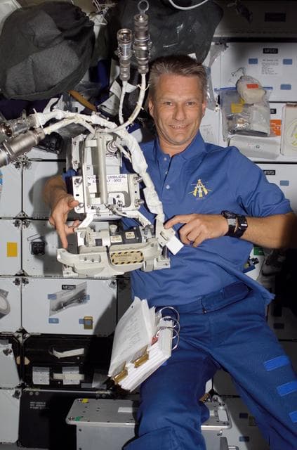 NASA image: Piers holds up an IUA removed during EVA 2 during STS-121 / Expedition 13 joint operations.