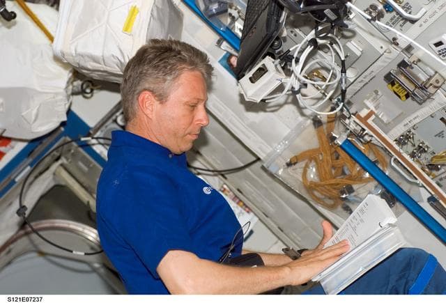 NASA image: Reiter reads procedures while working in the U.S. Lab during STS-121 / Expedition 13 joint operations